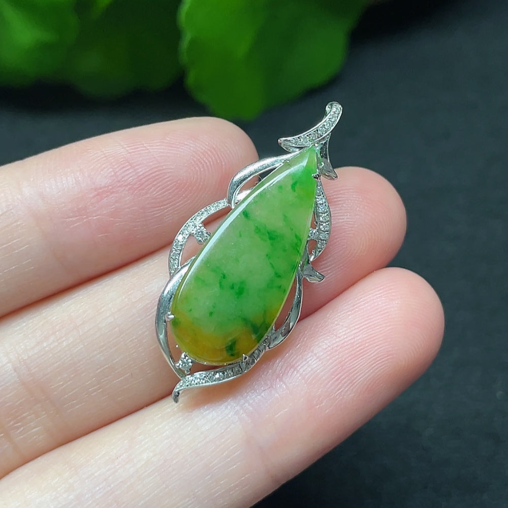 Jadeite teardrop pendant with 18K gold setting and diamond accents, hanging on a delicate necklace chain.