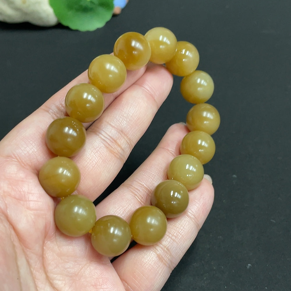 Huiliu HQ Hetian jade bracelet with 13.9mm beads, weighing approximately 65.4 grams, showcasing smooth, polished green jade stones.