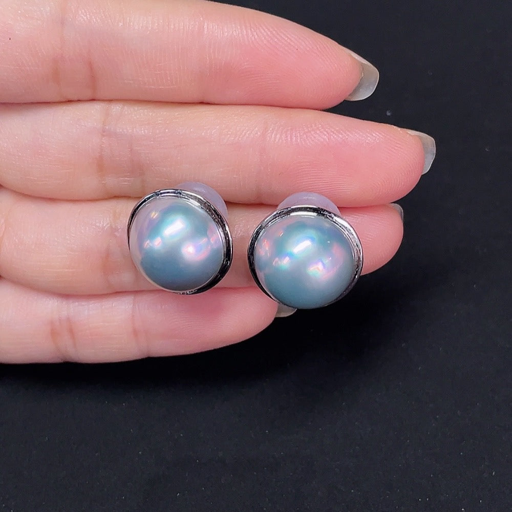 Composite saltwater pearl stud earrings with platinum settings and diamond accents, showcasing elegant jewelry design by HKHQ.