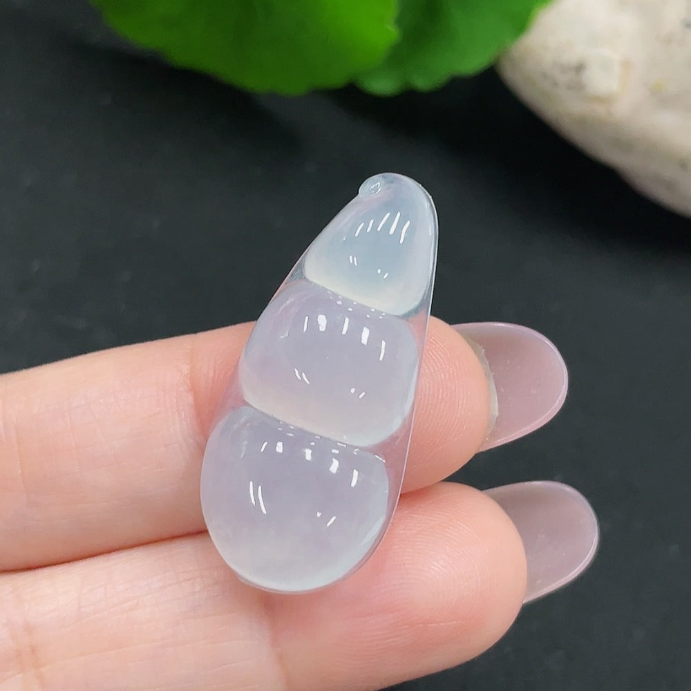 Huiliu Jadeite Lucky Bean Pendant featuring a smooth green jade stone with carved detailing, hanging from a delicate cord.
