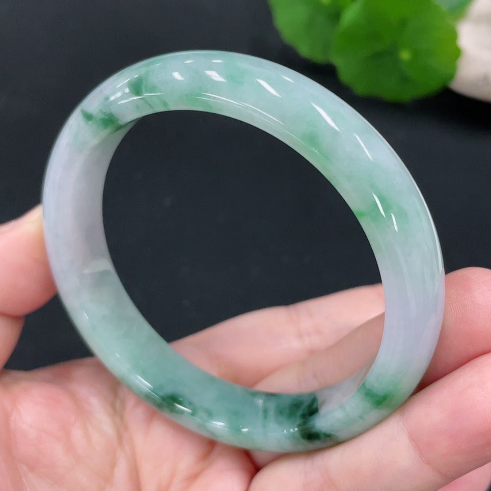 Huiliu certified jadeite round bangle showcasing smooth, polished green jade with a glossy finish on a plain background.