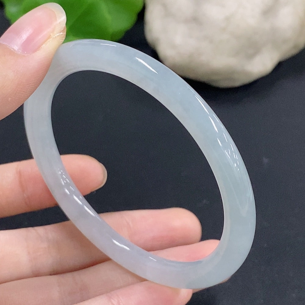Jadeite round bangle with a size of 55.7 and weight of 23.89g, crafted from green jade, displayed on a neutral background