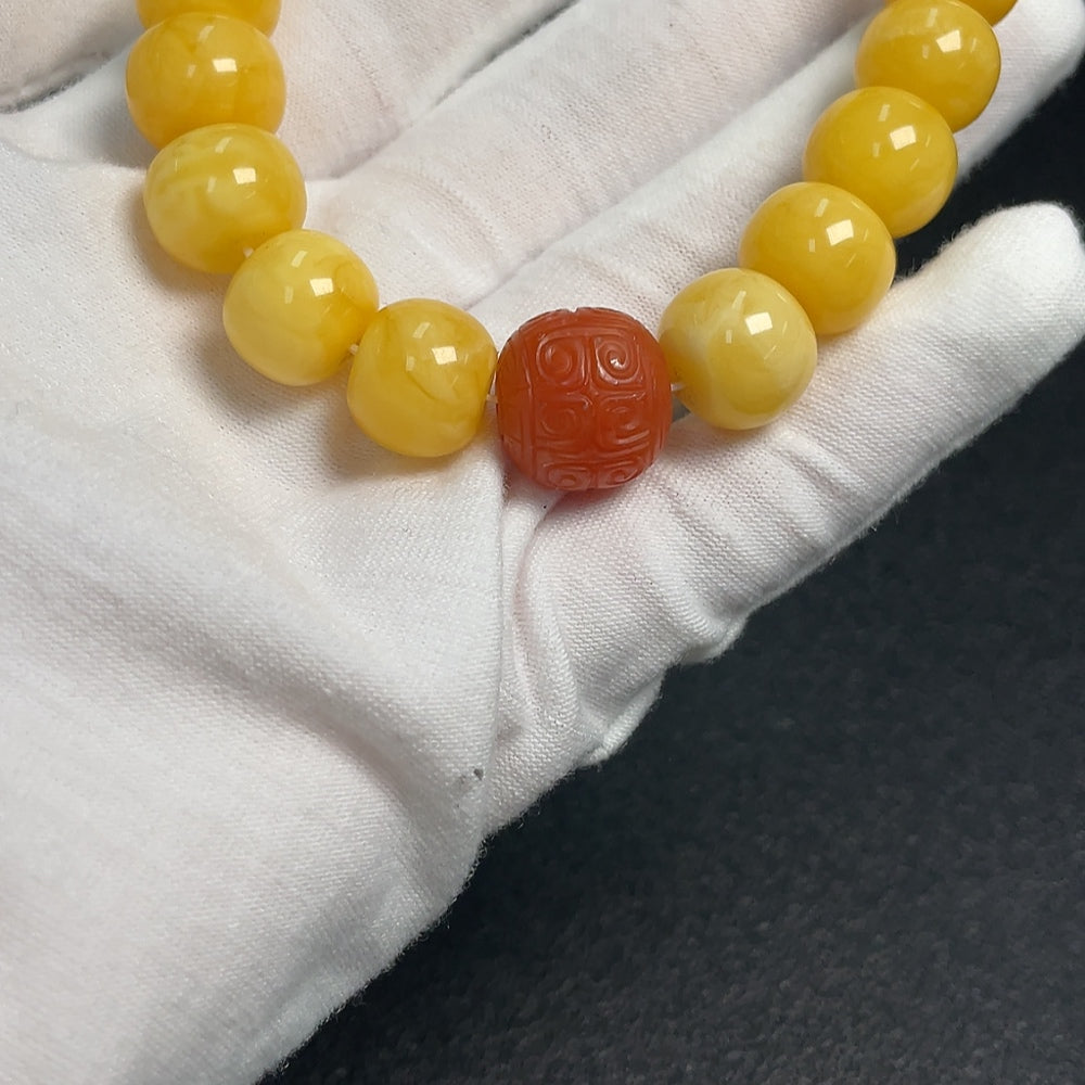 Amber Beeswax bracelet by HUILIU HQ featuring Southern Red Agate beads on a natural amber-colored string.