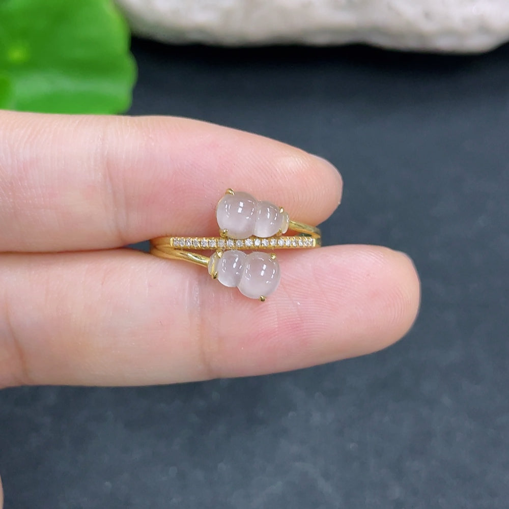 Elegant jadeite ring with 18K gold band and diamond side stones, showcasing intricate craftsmanship and luxurious design.