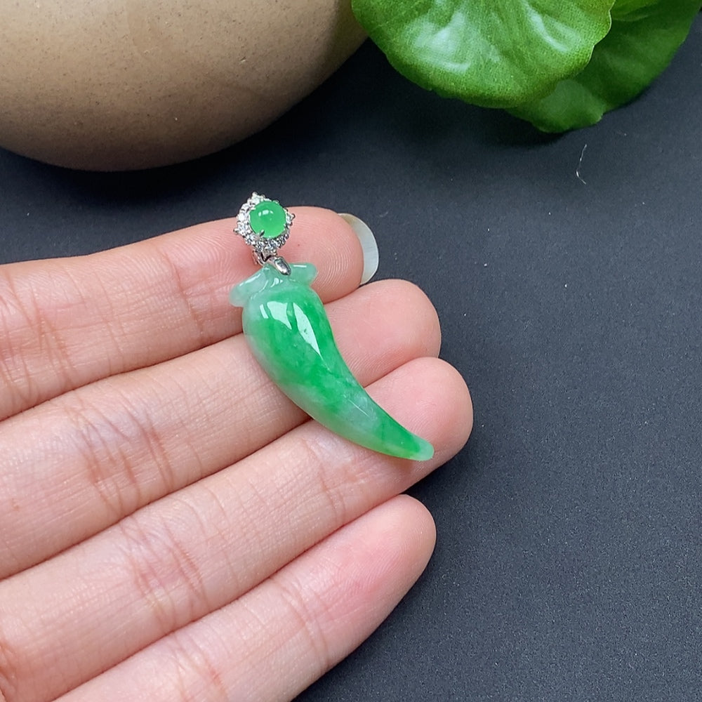 Jadeite pendant featuring a chili design with diamond accents set in 18K gold, displayed on a necklace.
