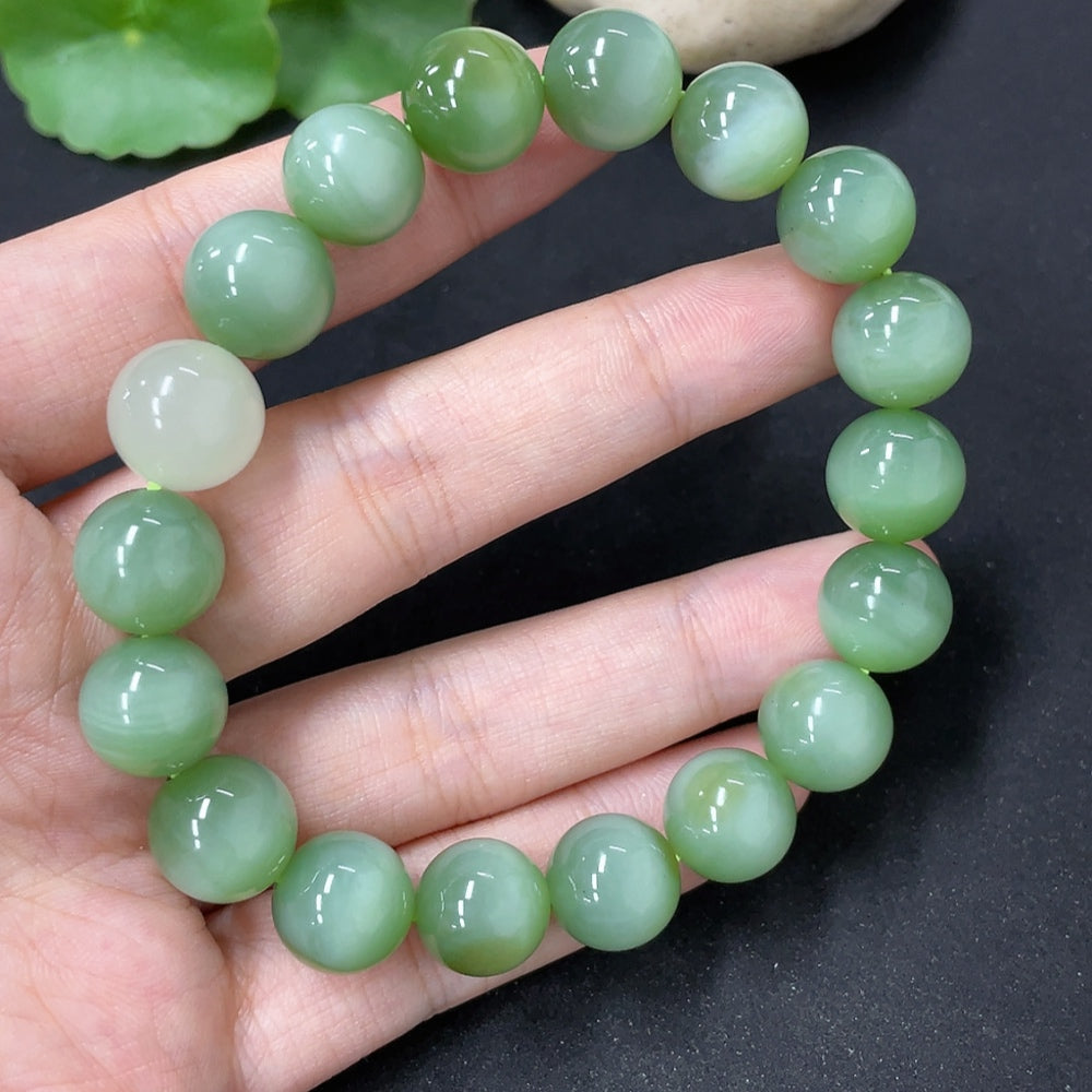HKHQ Hetian Jade bracelet with round beads, showcasing smooth, polished green jade stones on a delicate string.