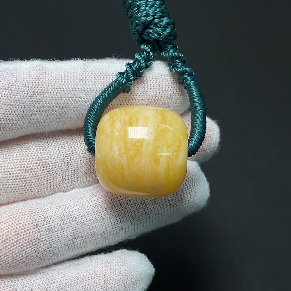 Amber beeswax pendant with cord, weighs approximately 10.99g, featuring natural amber stone and handcrafted design by HKHQ.