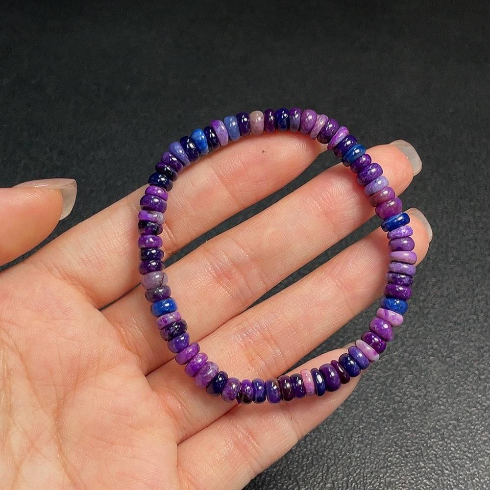 Purple Sugilite gemstone bracelet with 5.7mm beads, featuring mineral components and visible organic matter, from HUILIU HQ.