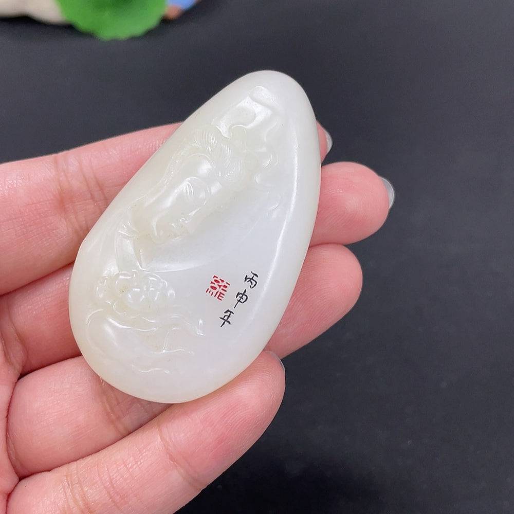 Huiliu certified Hetian jade Guanyin pendant with undetermined skin color, showcasing intricate carved details and smooth polished surface.