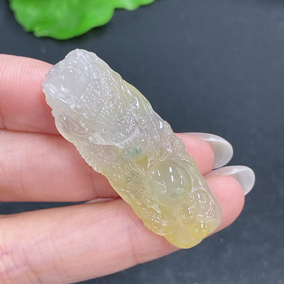 Jadeite pendant featuring a carved dragon plaque, approximately 10g, crafted from green jade by HKHQ, detailed and polished.