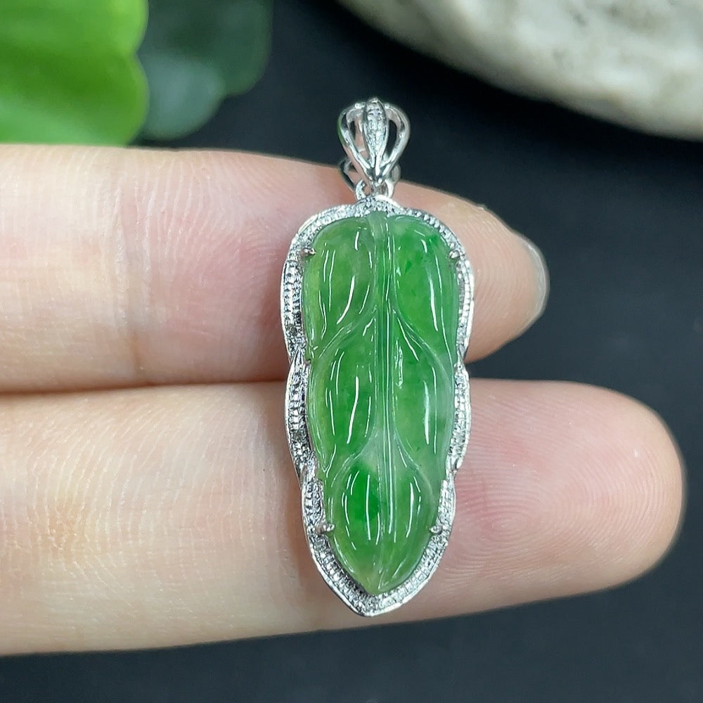 Jadeite leaf pendant in 18K gold with diamond accents, elegant necklace featuring detailed leaf design and sparkling gemstones.