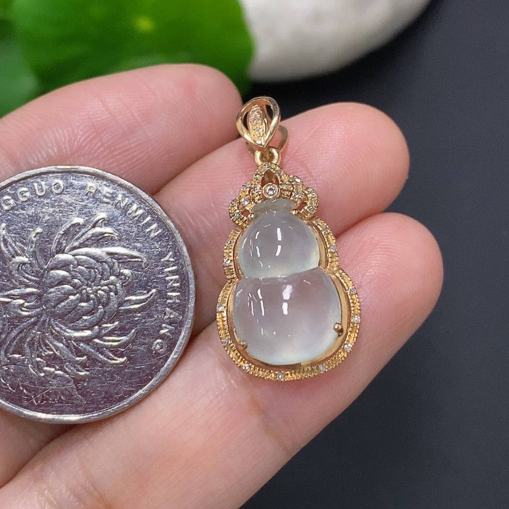 Jadeite inlaid gourd pendant with 18k gold and diamond accents, showcasing intricate craftsmanship and natural jade coloration.