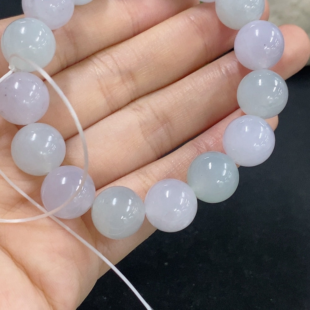 Jadeite bracelet from HKHQ with a 48.59g weight, featuring smooth, polished jadeite beads on a flexible string.