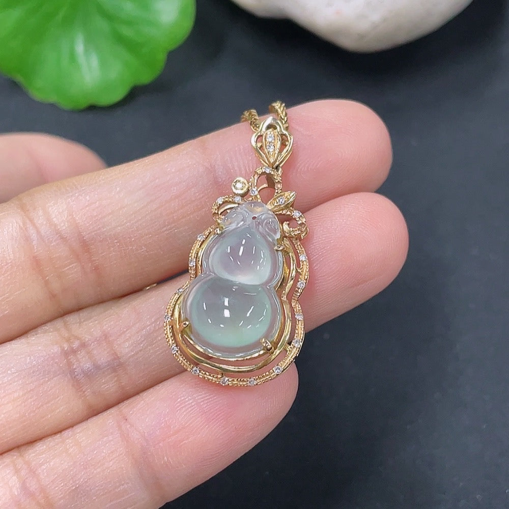 Jadeite gourd pendant set in 18K gold with diamond accents, featuring a polished jade jade pendant and matching earrings.