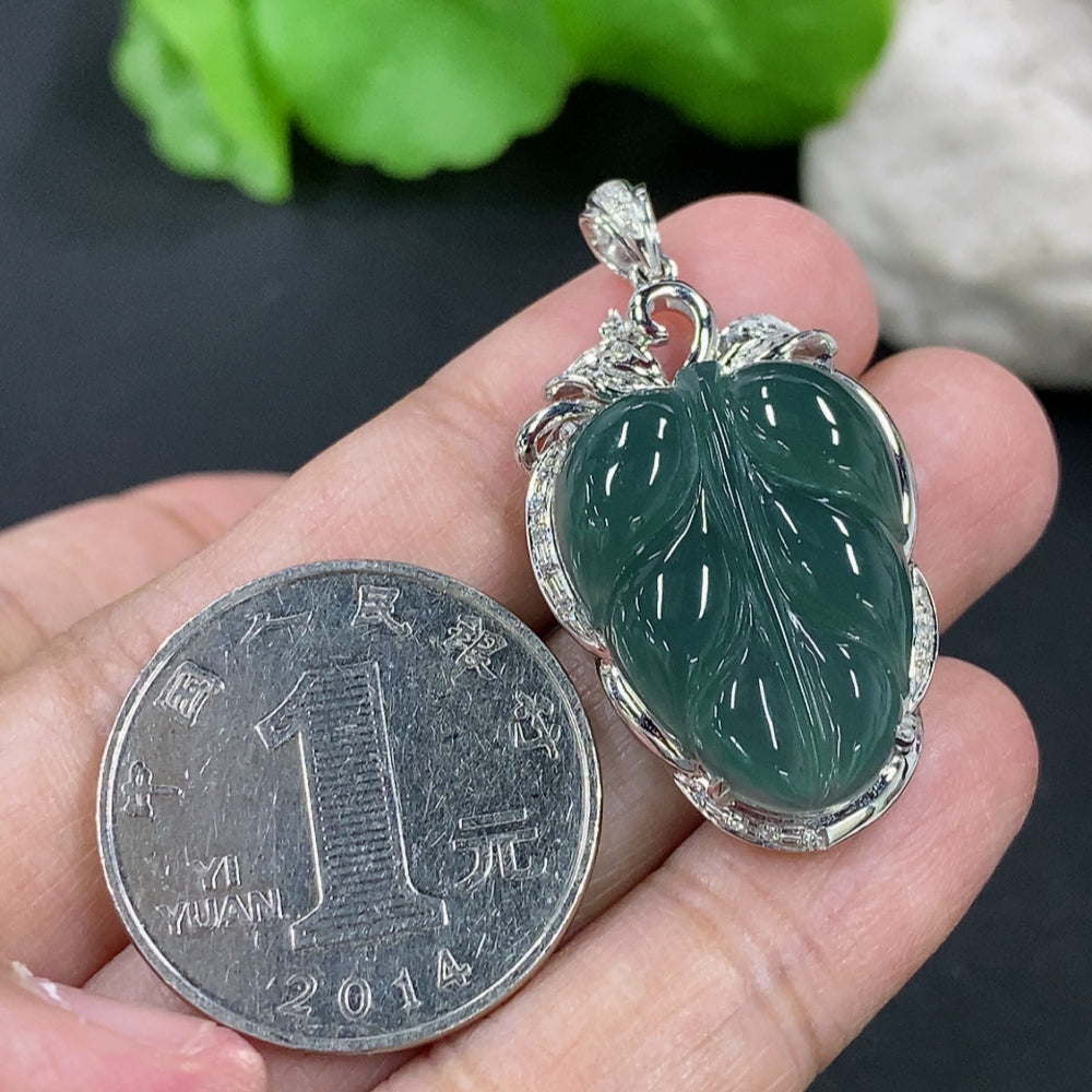 Jadeite leaf inlay pendant with 18K gold and diamond accents on a necklace, featuring detailed craftsmanship and elegant design.