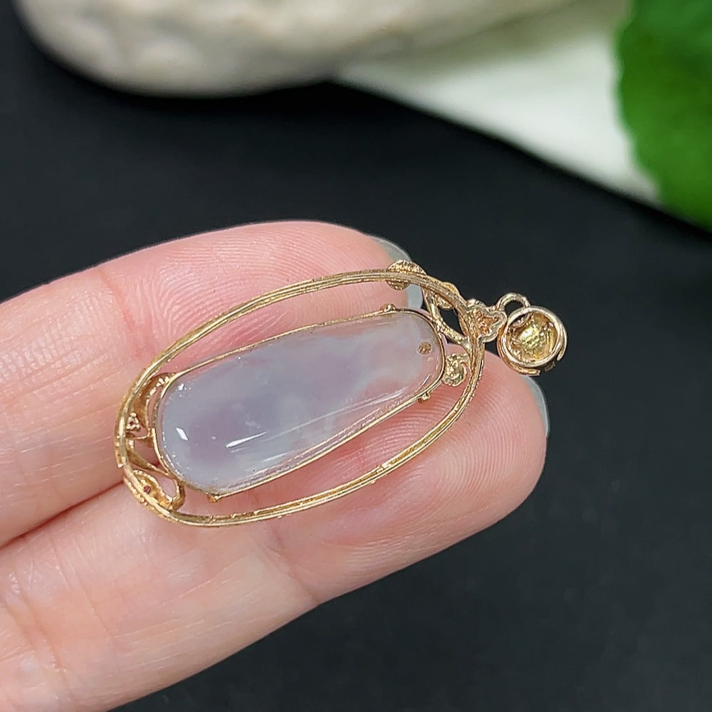 Jadeite pendant with 18K gold setting and diamond accents, weighing approximately 2.9g, displayed on a necklace.