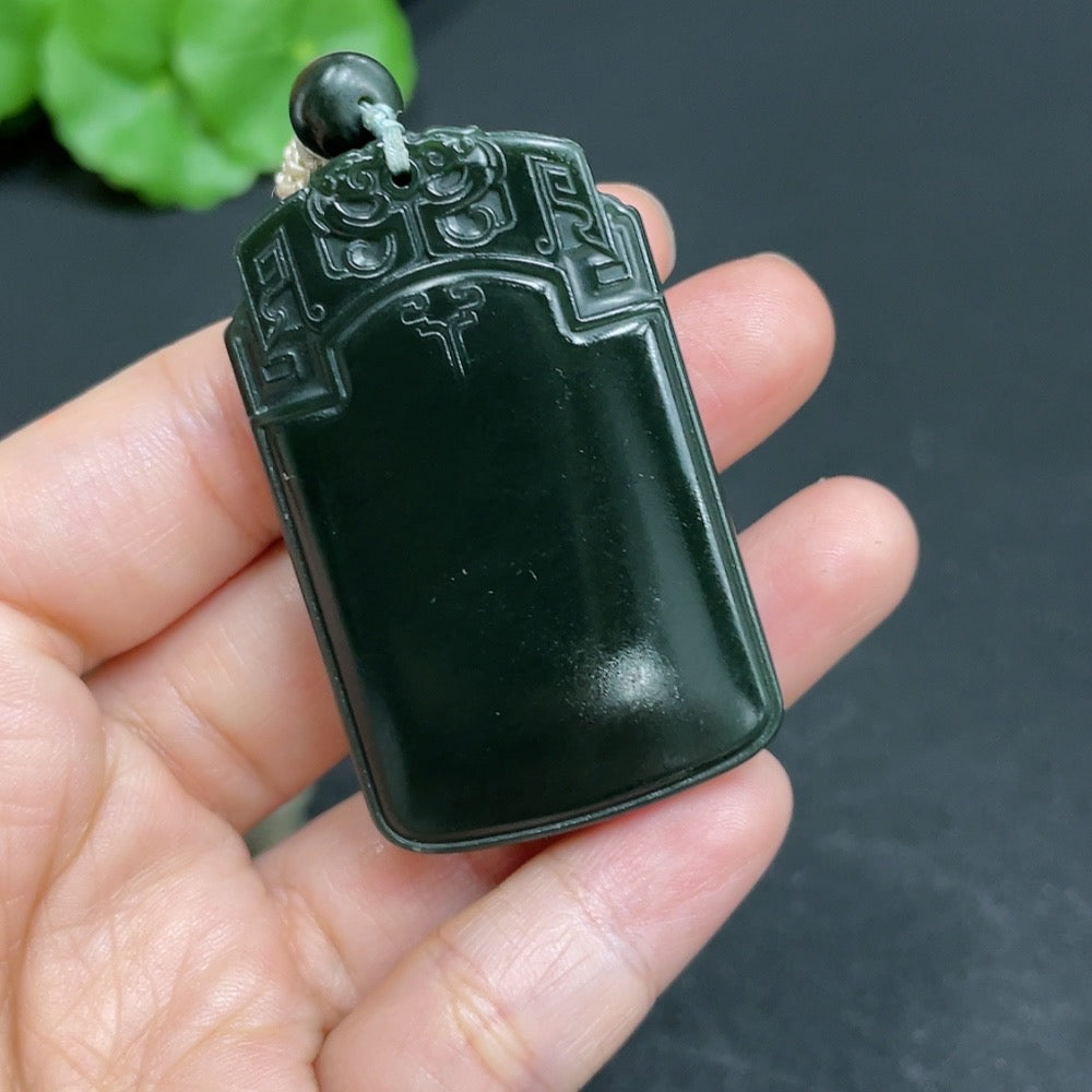 Huiliu certified Hetian jade pendant with antique plaque design and rope, showcasing smooth, polished green jade craftsmanship.