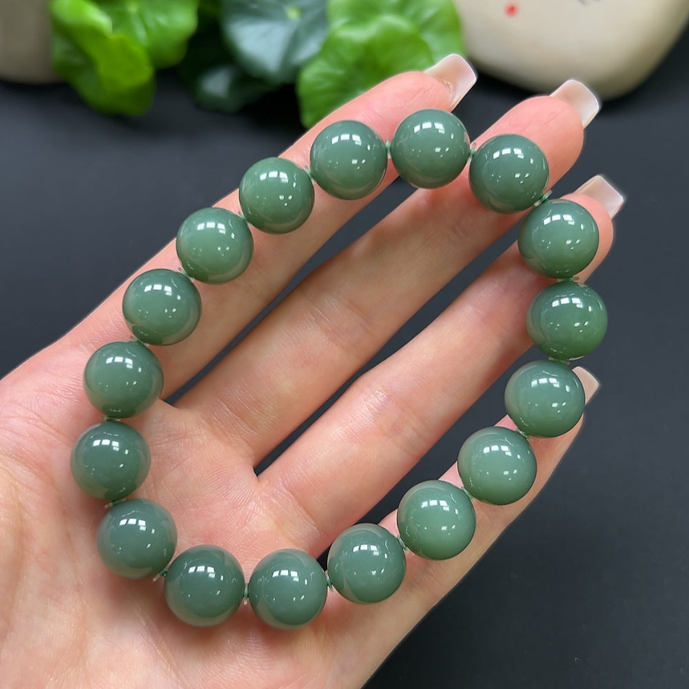 Hetian Jade bracelet from HKHQ featuring smooth, polished green jade beads, weighs 45 grams, and is displayed in a close-up view.