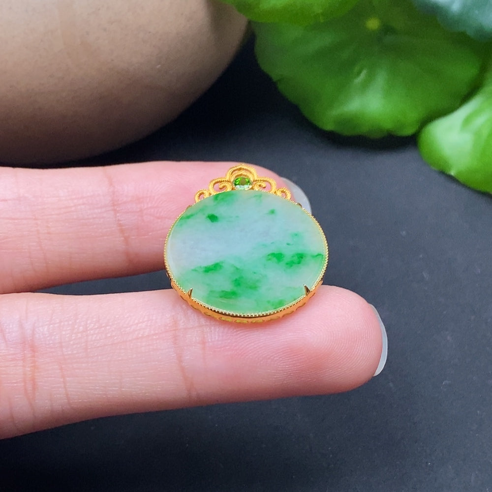 Elegant jadeite plain pendant on a silver chain, showcasing a smooth, polished 18K gold setting in a close-up view.