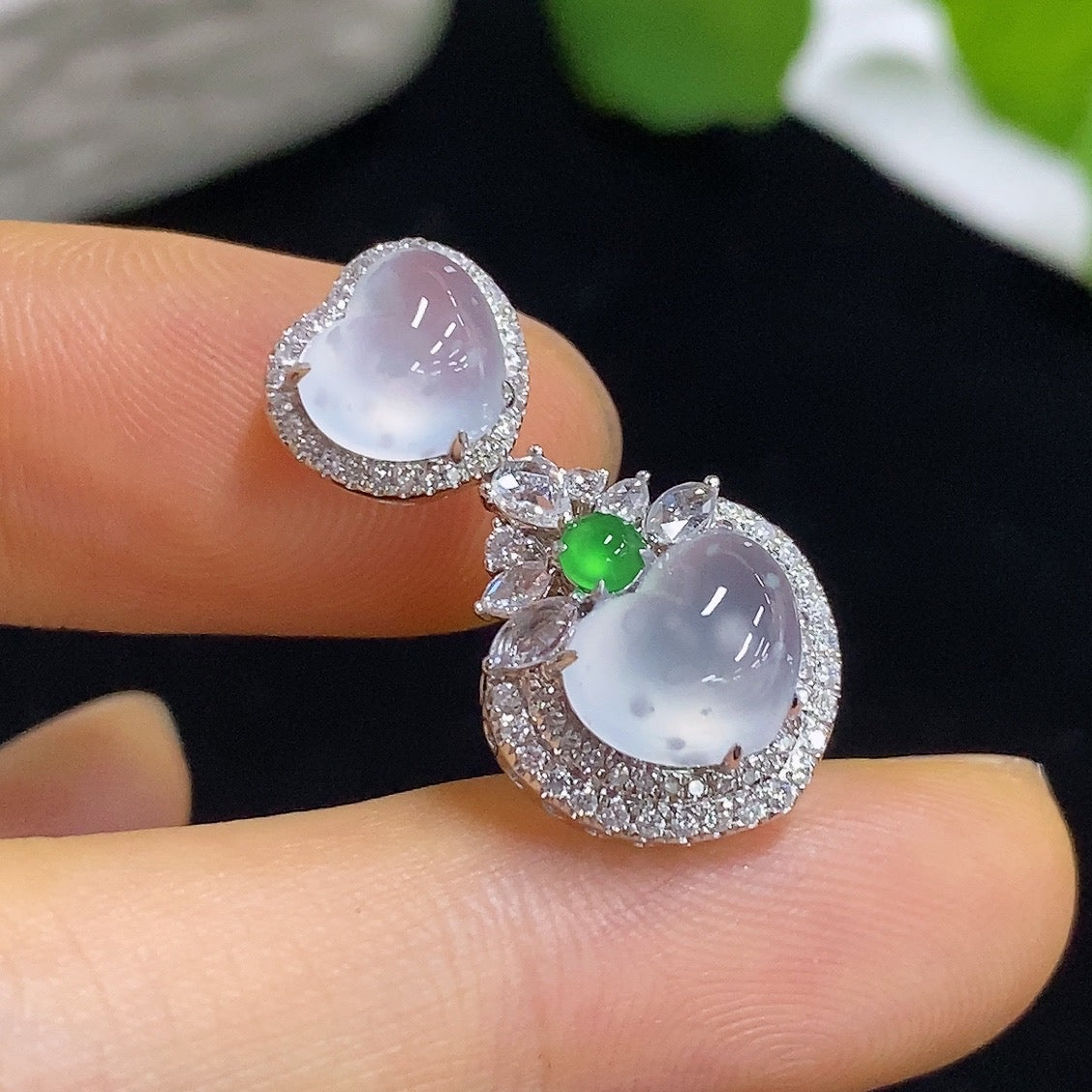 Jadeite heart-shaped pendant with 18K gold and diamond accents, showcasing a polished jade surface and delicate design.