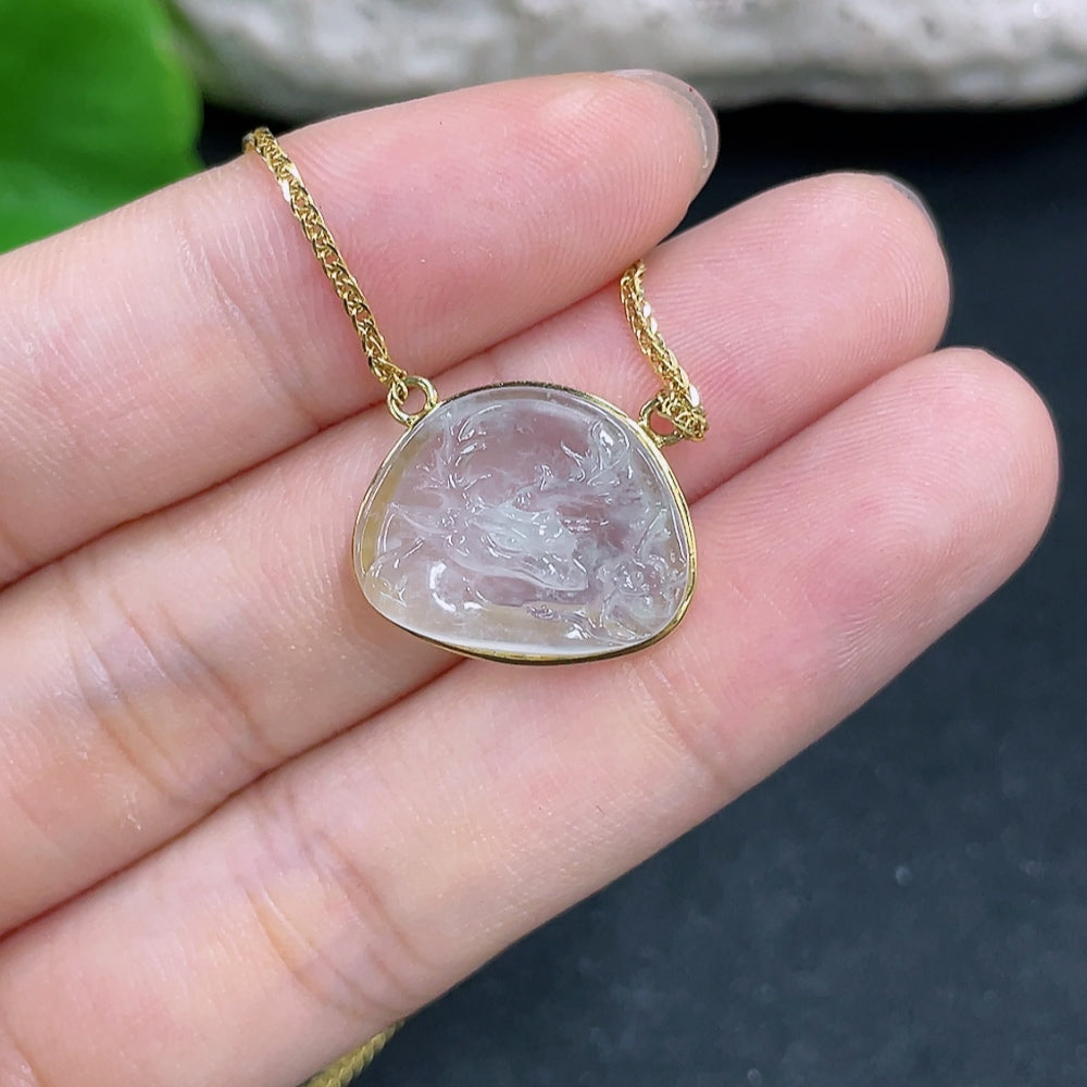 Jadeite pendant with 18K gold setting on chain, elegant necklace featuring a smooth, polished jadeite gemstone and gold clasp.