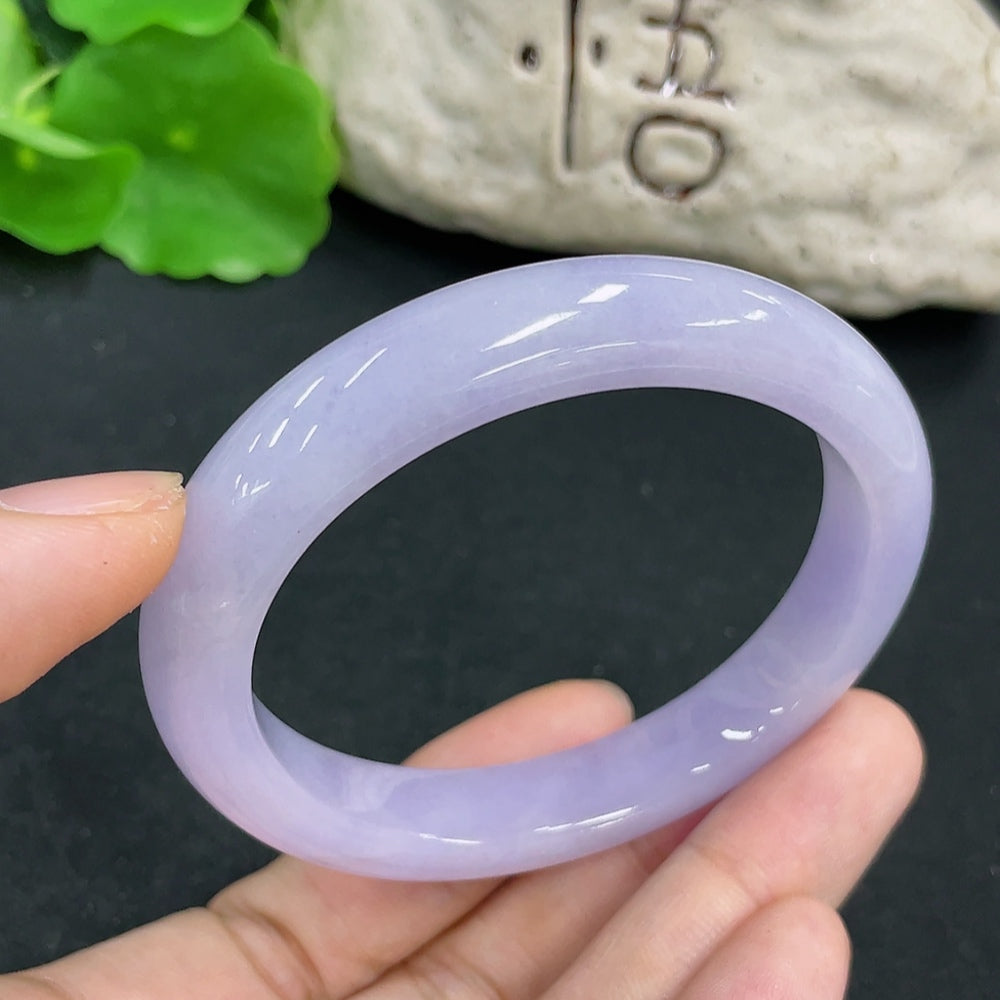 Jadeite Concubine Bracelet by HKHQ featuring smooth, polished green jade with intricate design details.