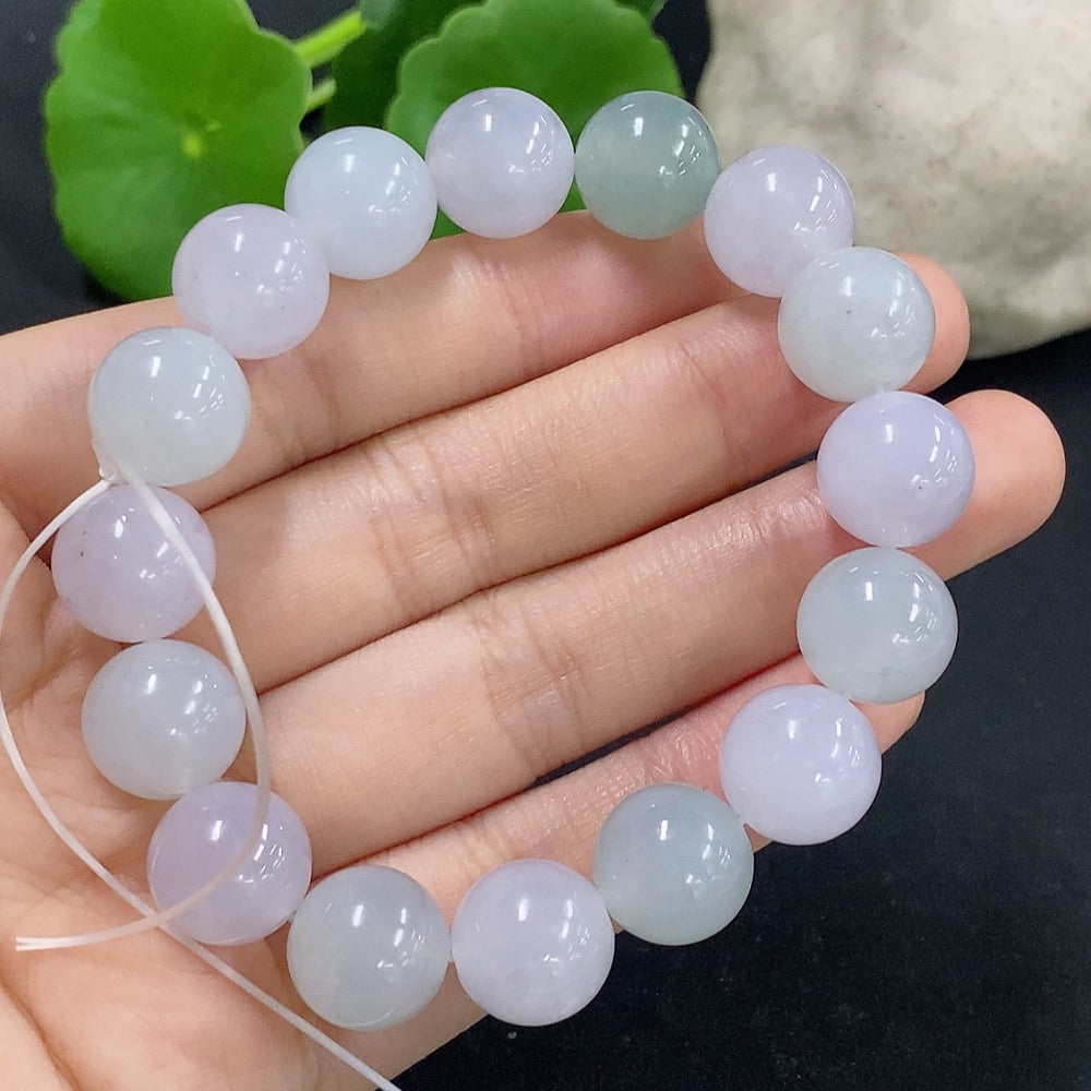 HKHQ jadeite bracelet weighing 48.59g, featuring smooth, polished jadeite beads on a flexible bracelet design.