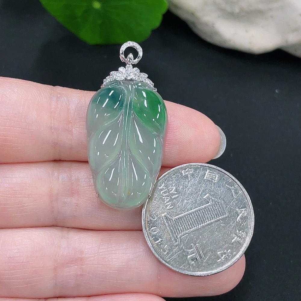 Jadeite pendant leaf with 18k gold accents and diamond details, featuring lush green jade and intricate design.