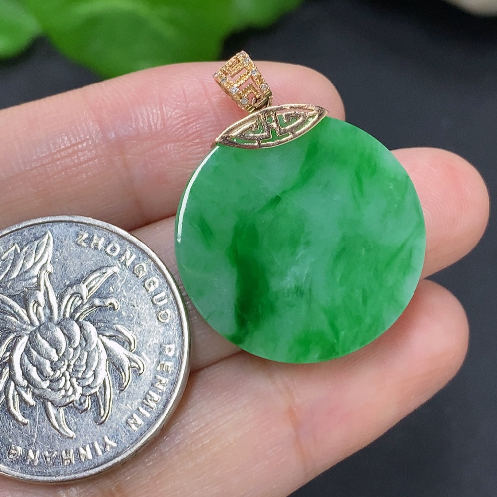 Jadeite plain pendant with 18K gold bail, set with diamonds, showcasing smooth green jade stone on a jewelry display.