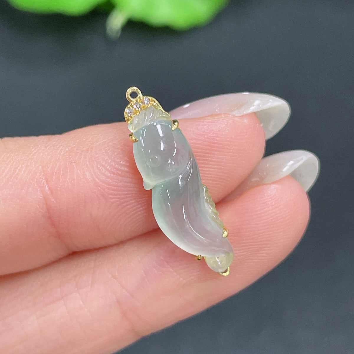 Jadeite pendant with 18k gold inlay and diamond accents, weighing approximately 1.21 grams, from HKHQ.