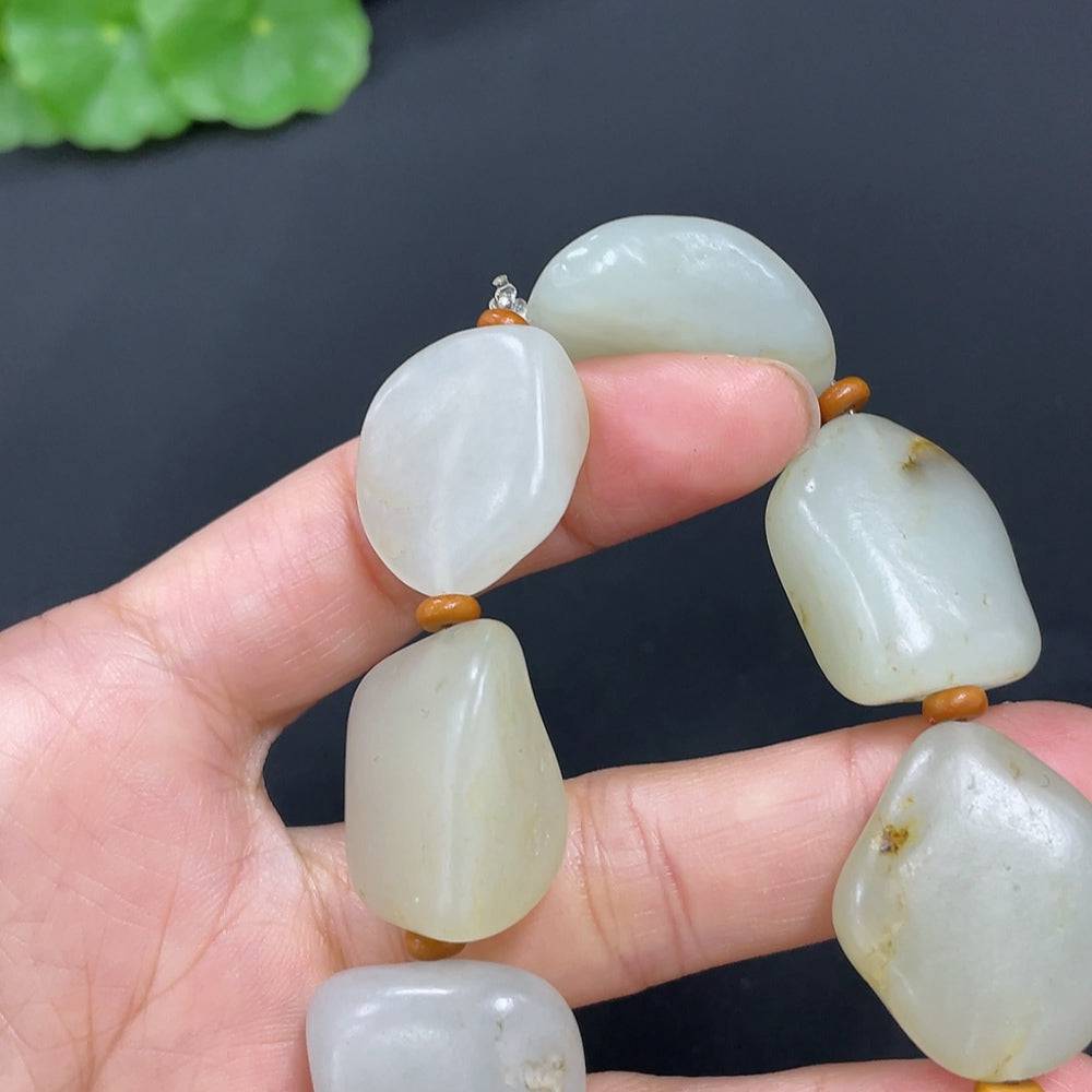 Huiliu HQ Hetian Jade bracelet featuring smooth, polished green jade beads on a natural skin tone background