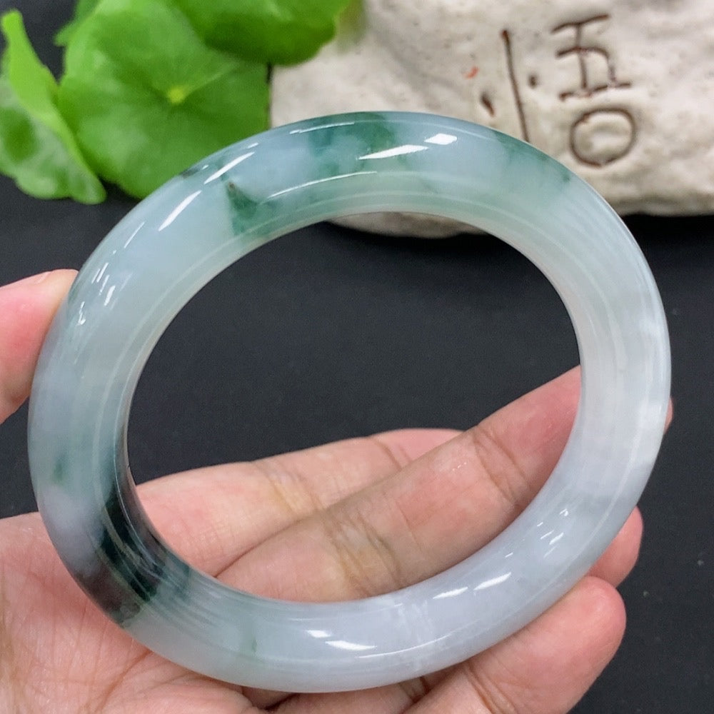 HKHQ Jadeite round bangle, size 54.9, weighing approx. 65.2g, featuring a smooth polished surface with mineral inclusions.