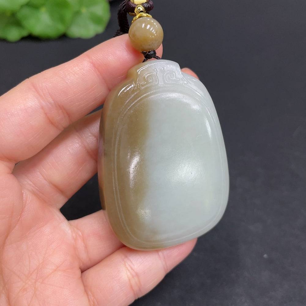 Huiliu certified Hetian jade pendant featuring a plain, smooth jade stone in a natural, polished finish, showcasing traditional craftsmanship.