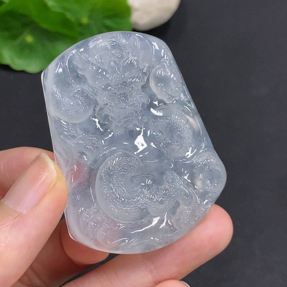 Jadeite pendant featuring a soaring dragon design, crafted by HUILIU HQ, with intricate detailing on a polished jade surface.