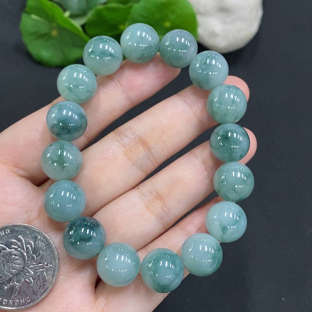 Huiliu Jadeite bead necklace with 12.4mm polished jade beads, showcasing a smooth, elegant design on a white background.