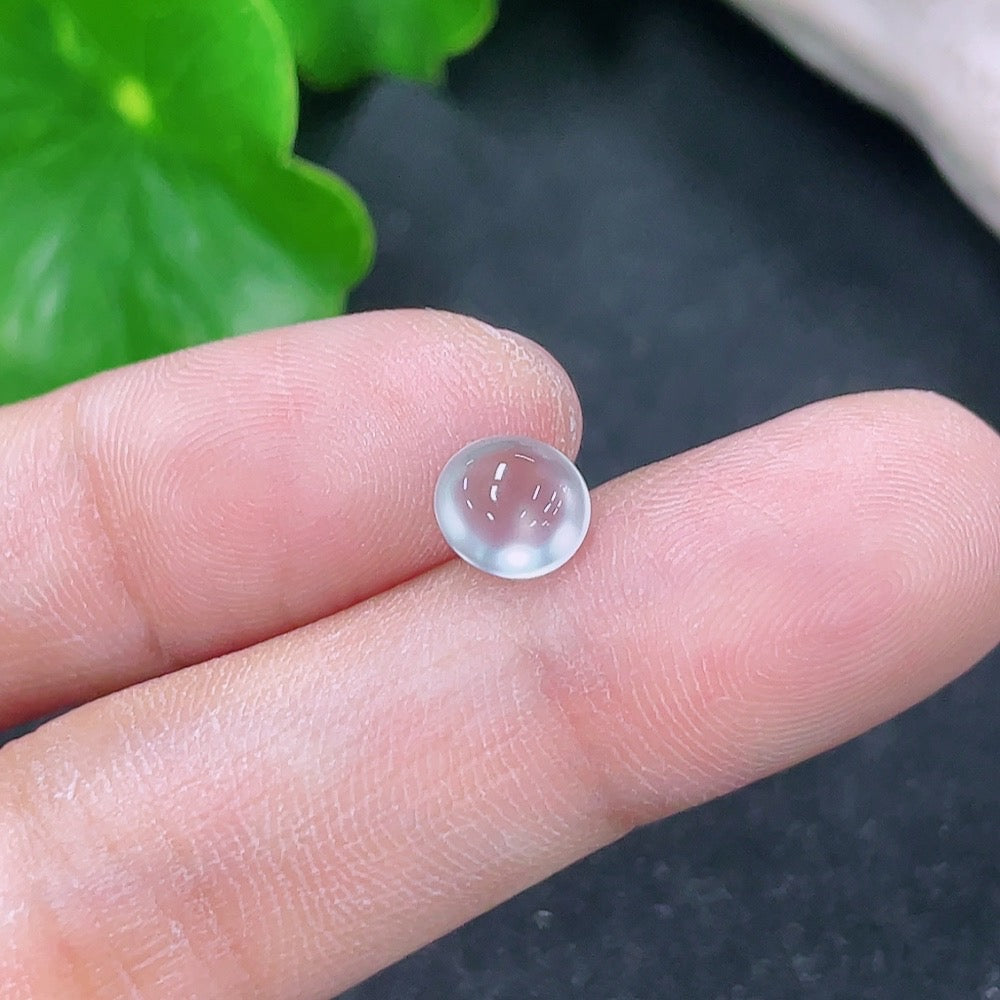 Small green jadeite cabochon jewelry piece from HKHQ, weighing 0.19g, with smooth polished surface and vibrant color.