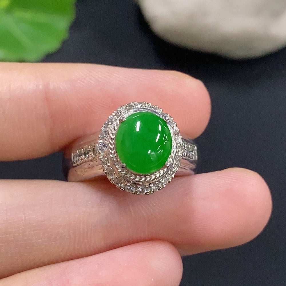 Jadeite cabochon gemstone in a non-gold jewelry setting, showcasing smooth, polished green stone with a sleek design.
