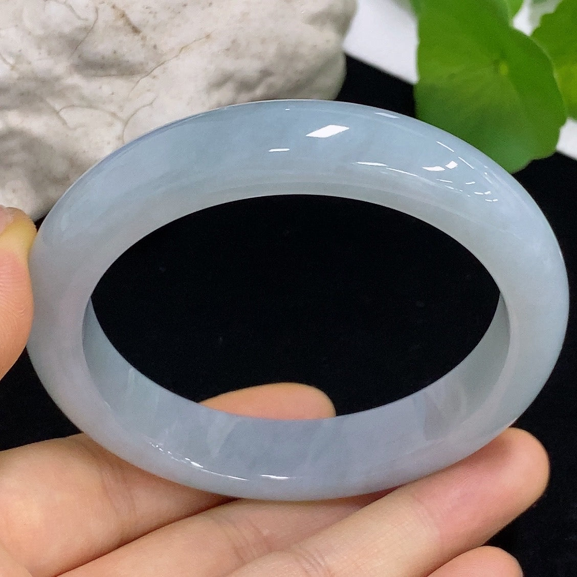 HKHQ jadeite round bangle in size 56.7 with a smooth, polished surface and a weight of 61.15 grams, showcasing elegant craftsmanship.