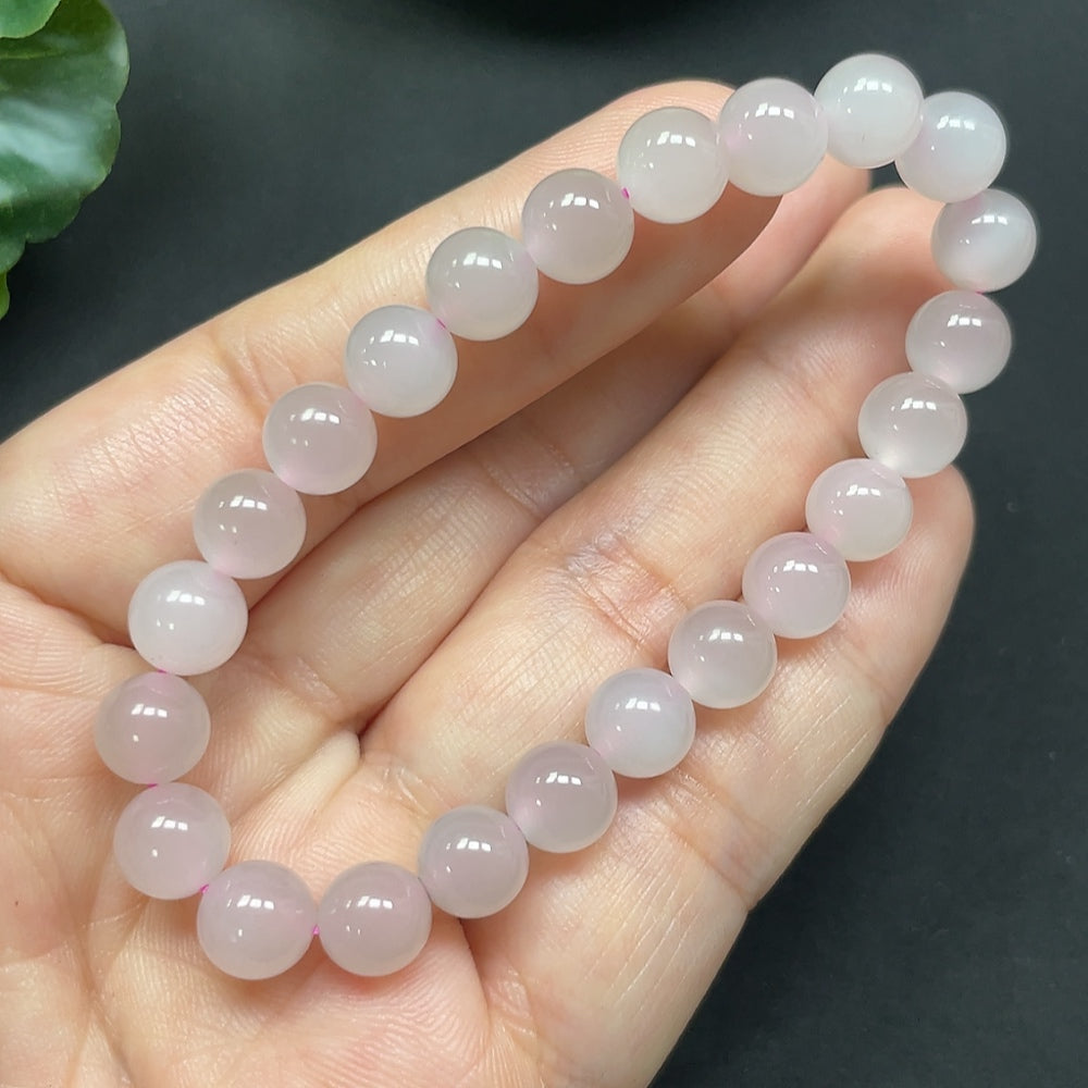 HKHQ Hetian Jade bracelet featuring 7.7mm smooth, polished jade beads on a durable elastic cord.