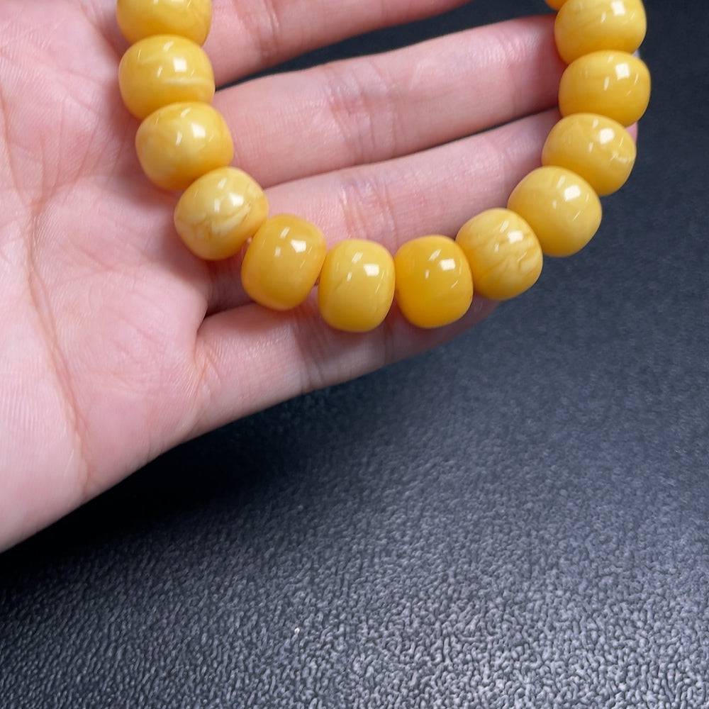 Huiliu Amber Beeswax Bracelet with 12.4mm beads, natural amber jewelry, stylish and handcrafted accessory.