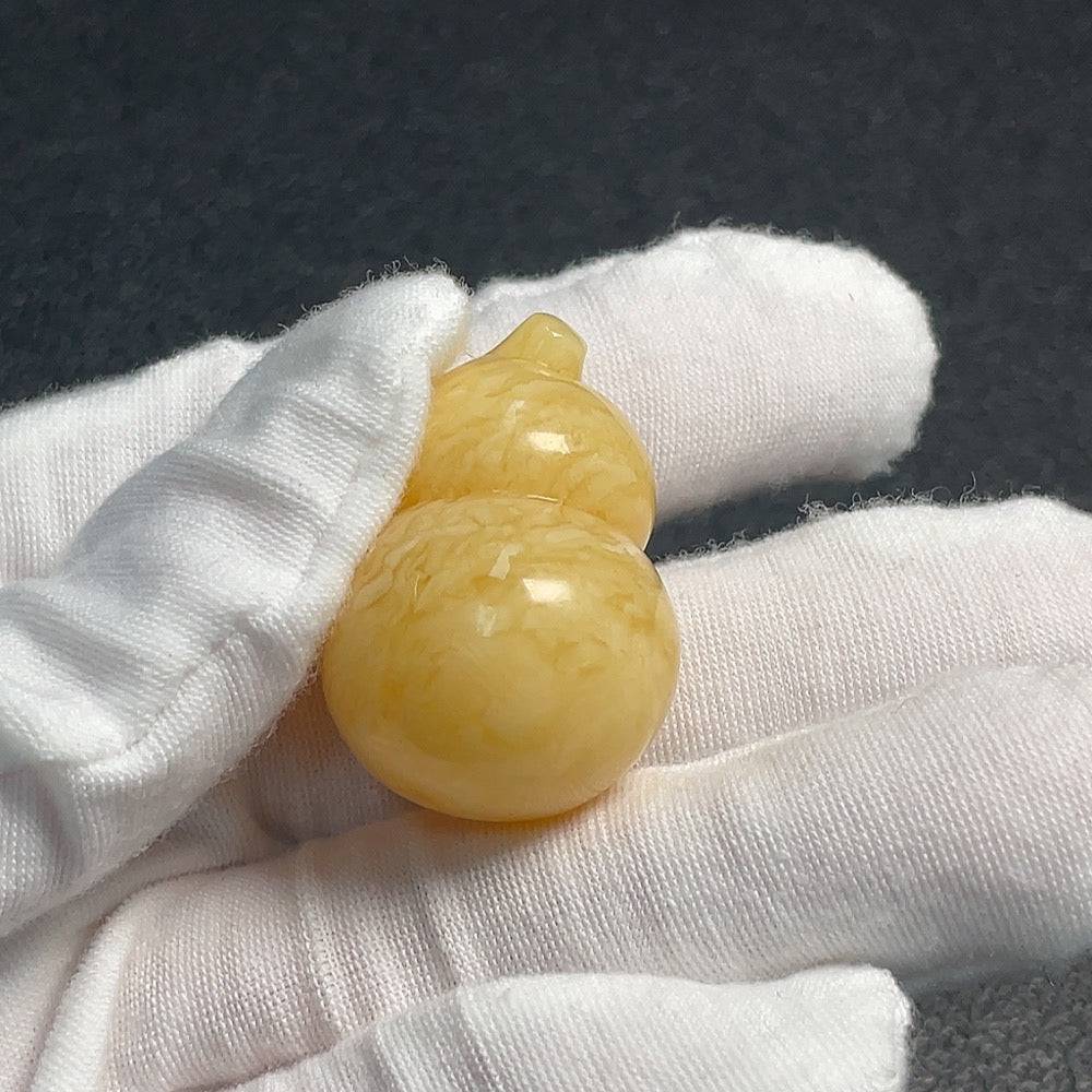 Huiliu Certified amber beeswax jewelry featuring natural amber beads and intricate design on a white background.