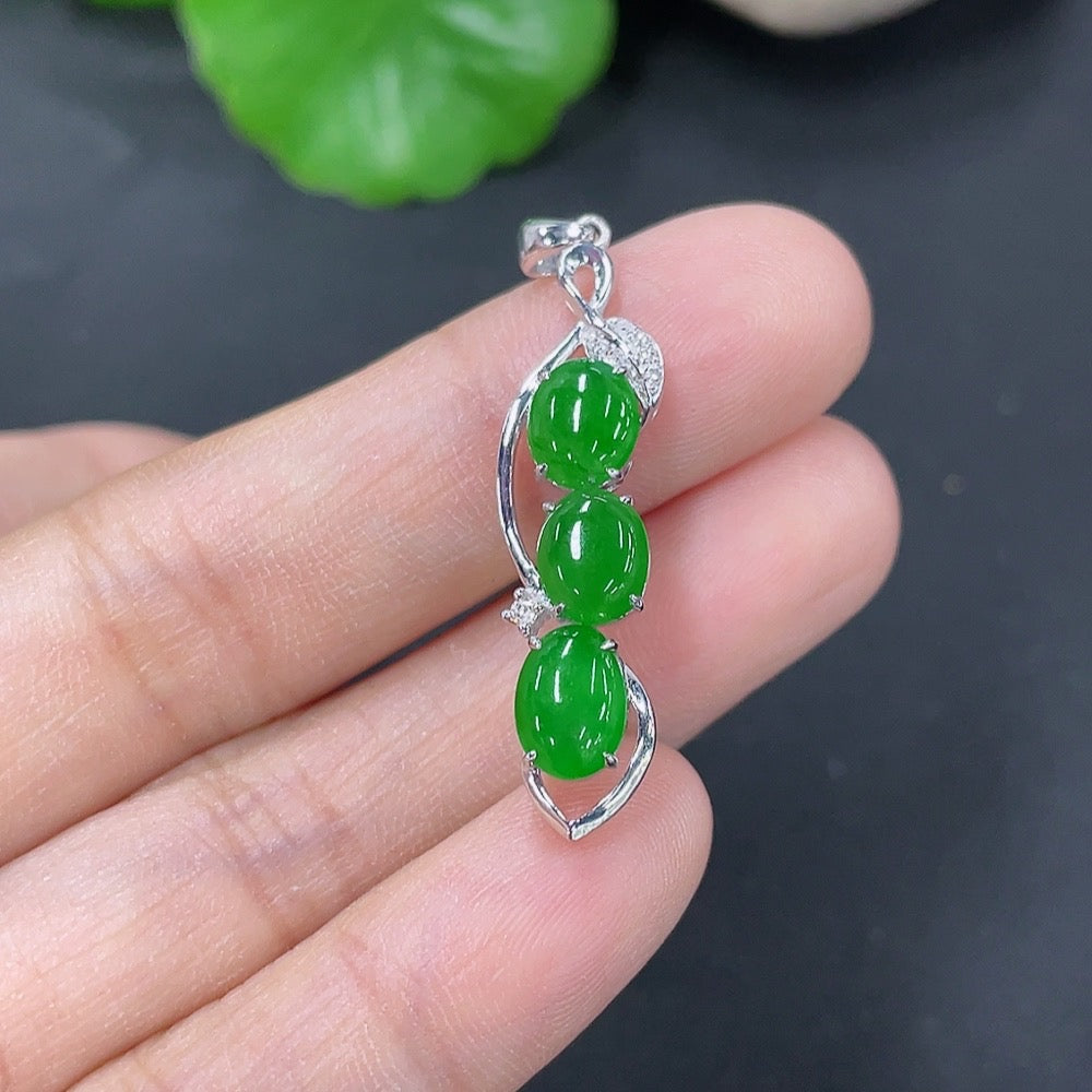 Jadeite bezel-set cabochon pendant with 18k gold and diamond accents, showcasing a smooth green jade stone and elegant design.