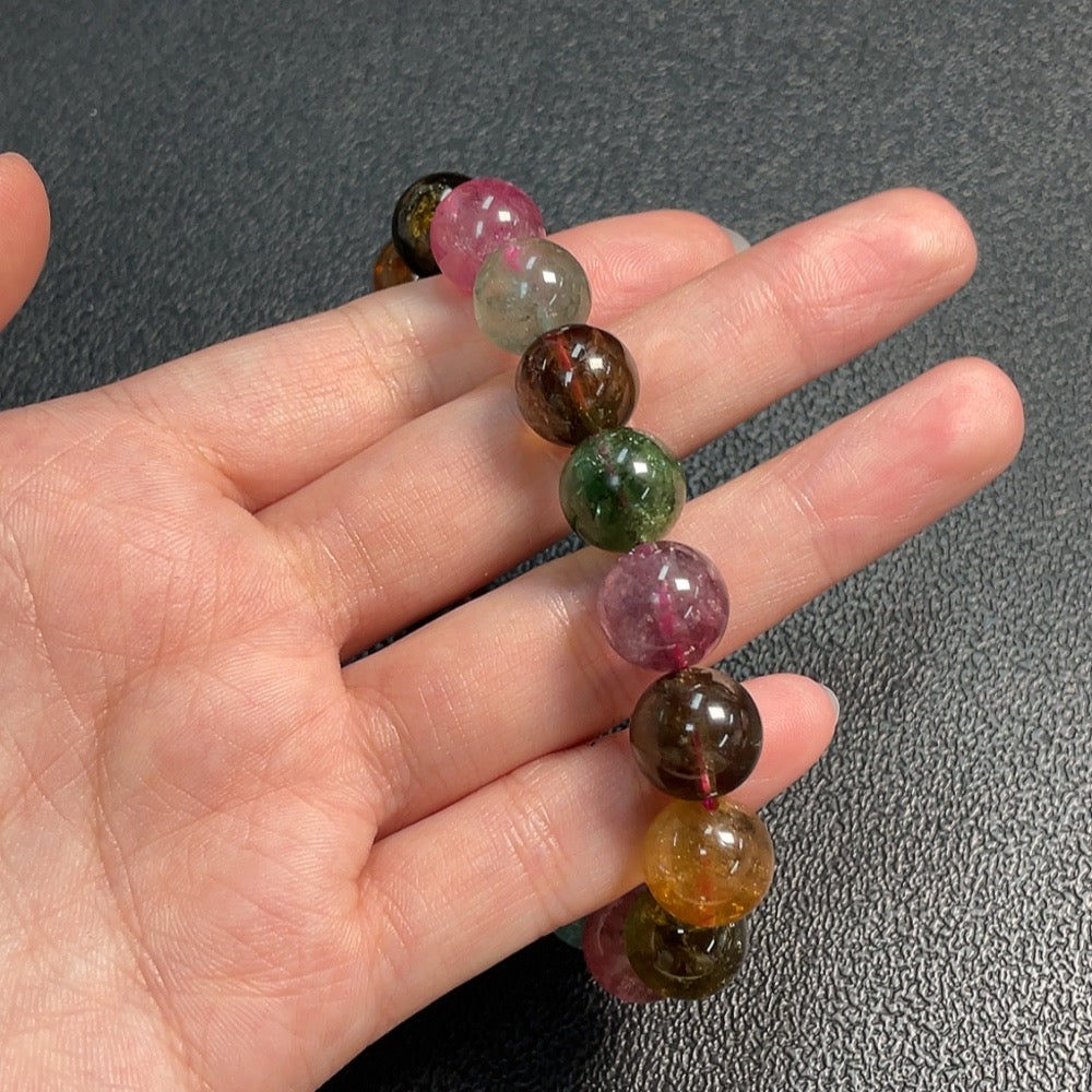 Huiliu gemstone tourmaline bracelet with visible organic matter, 11.7mm size, featuring natural gemstone details and vibrant colors.