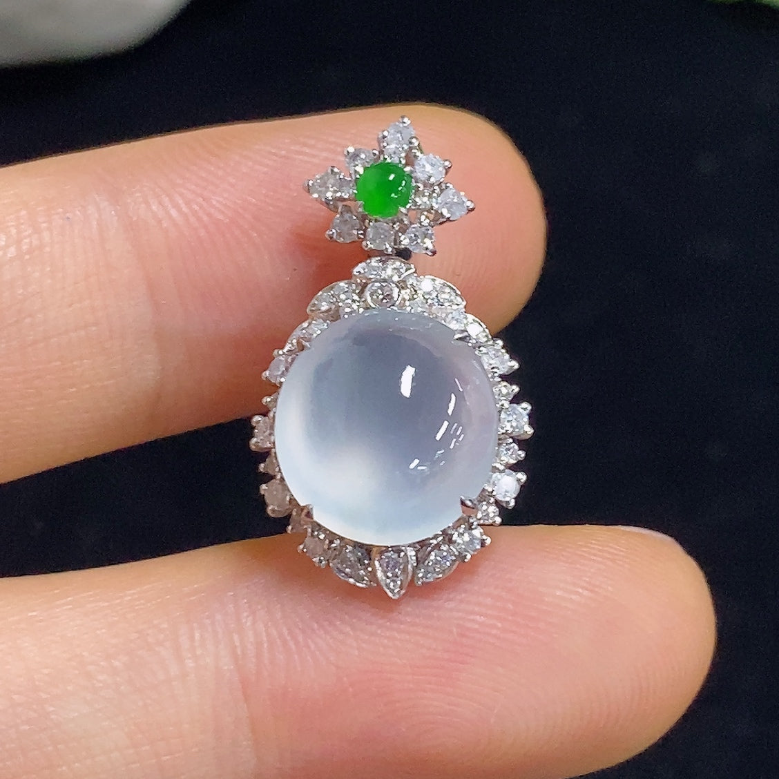 Jadeite pendant with 18K gold and diamond accents, showcasing a polished green jade stone on a delicate necklace.