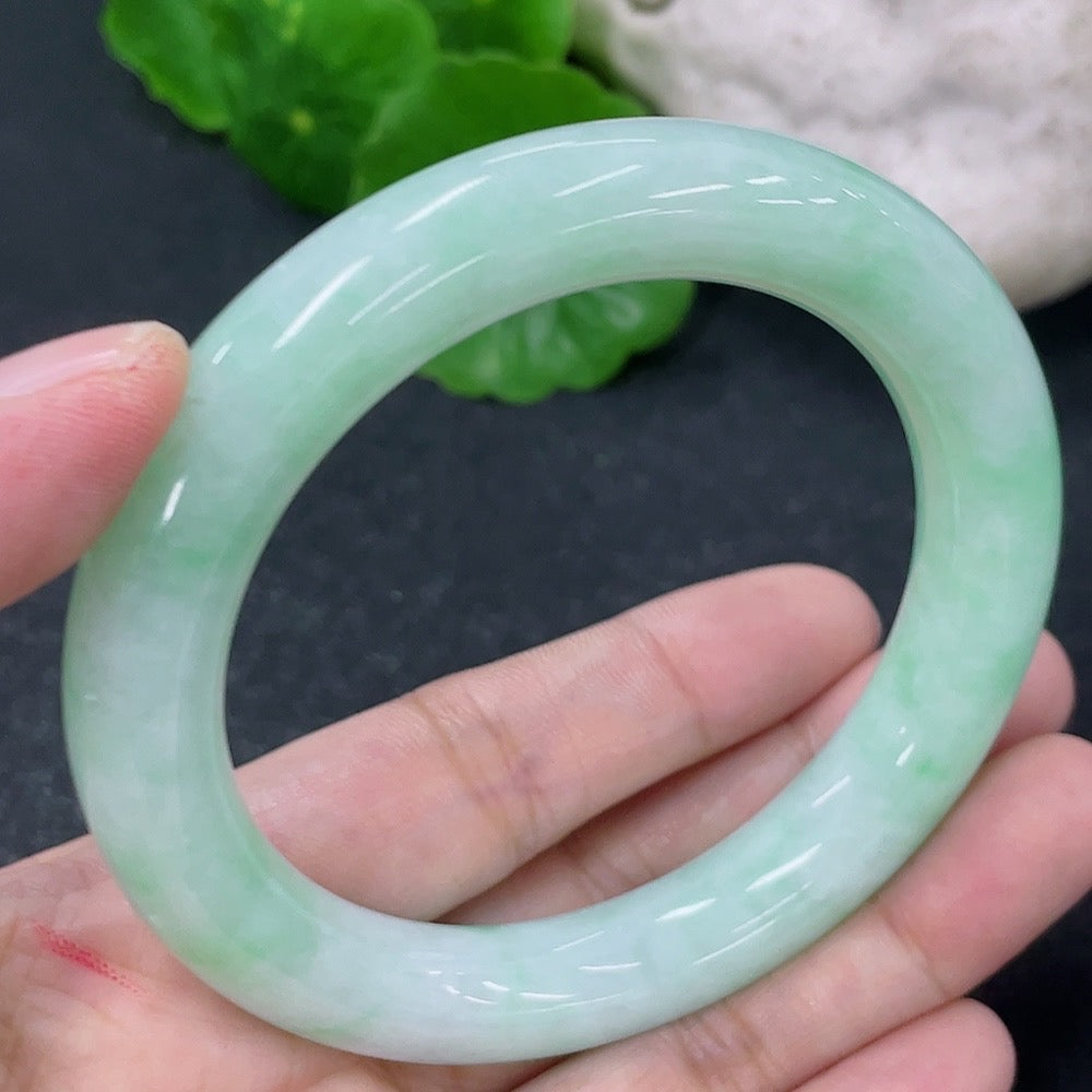 HKHQ jadeite round bangle with 53.5mm diameter, approximately 55.86g, showcasing smooth, polished surface and vibrant green hue.