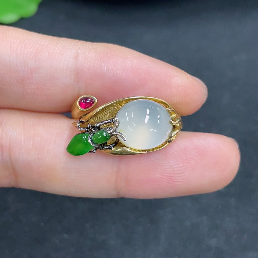 Jadeite ring with 18k gold setting, size 14, weighing approximately 9.5g, featuring a smooth, polished jade stone.