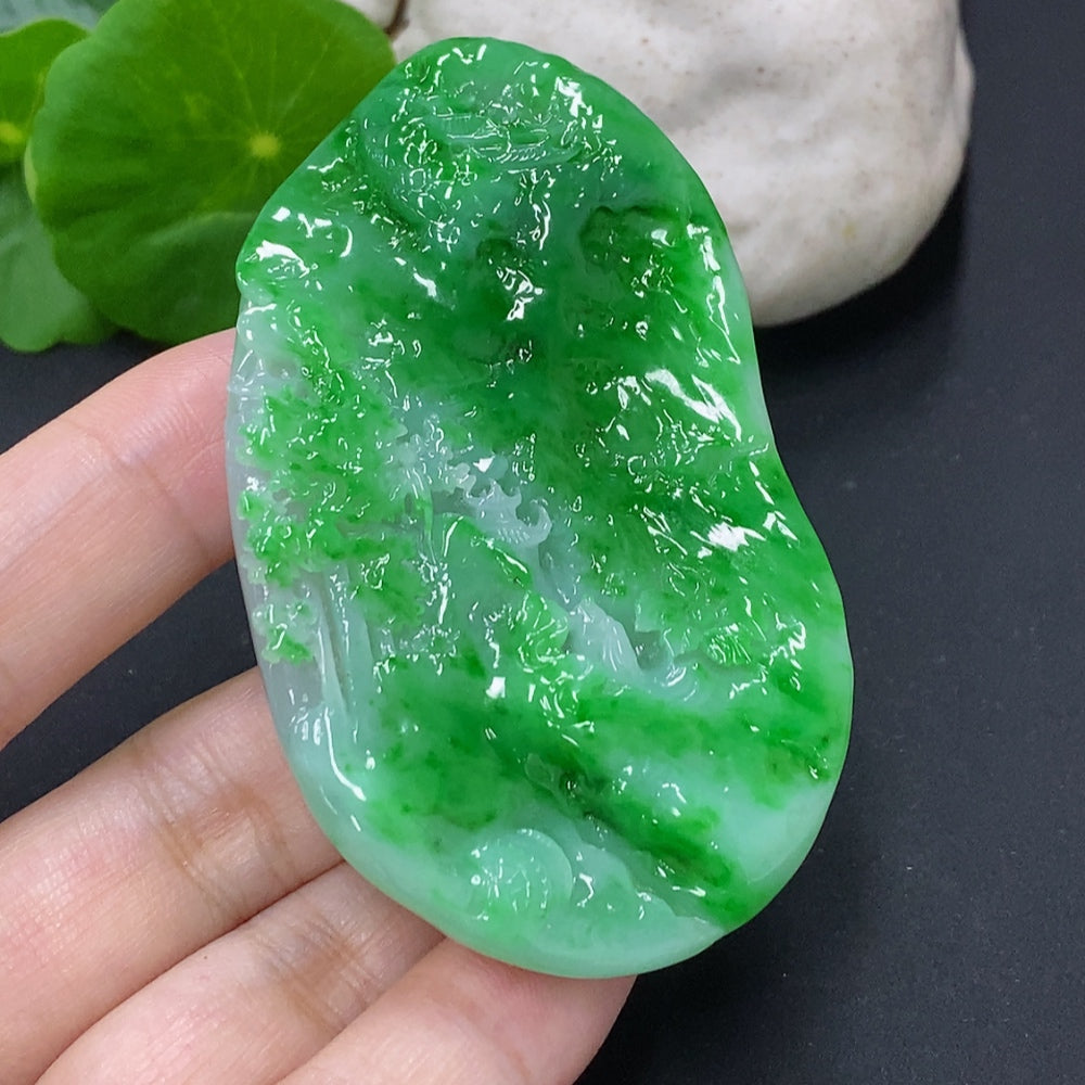 Jadeite landscape pendant from HKHQ featuring a carved jade pendant with detailed mountain and river scene, weighs approximately 65.3 grams.