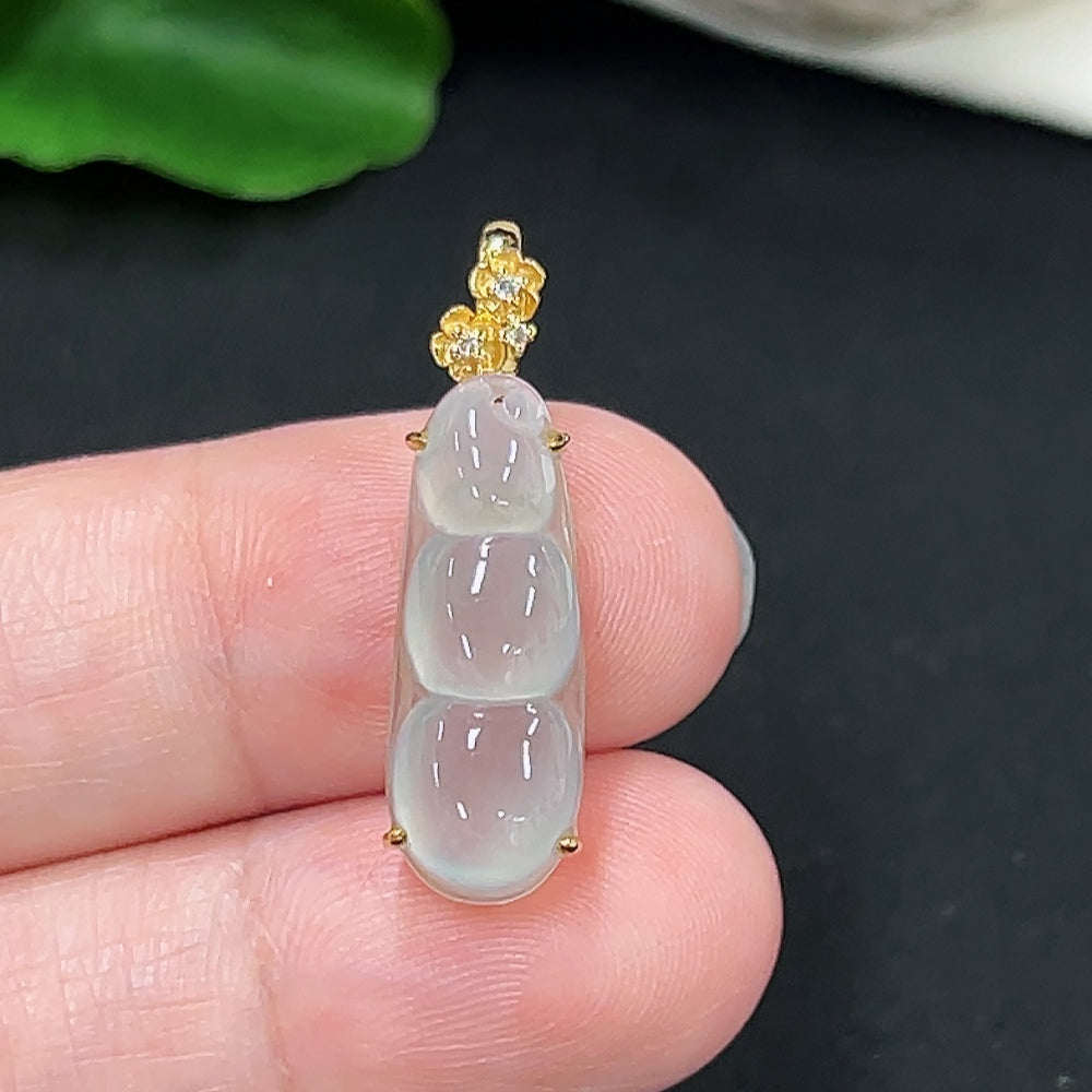 Jadeite auspicious bean pendant in 18K gold with diamond accents, displayed as a jewelry necklace.