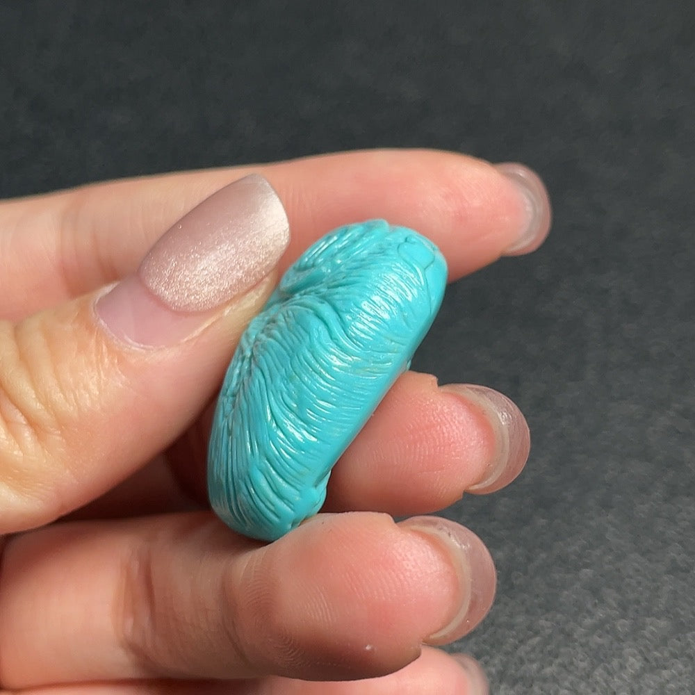 Turquoise gemstone pendant weighing approximately 10.2 grams, showcasing vibrant blue-green hues and polished surface by HUILIU HQ.