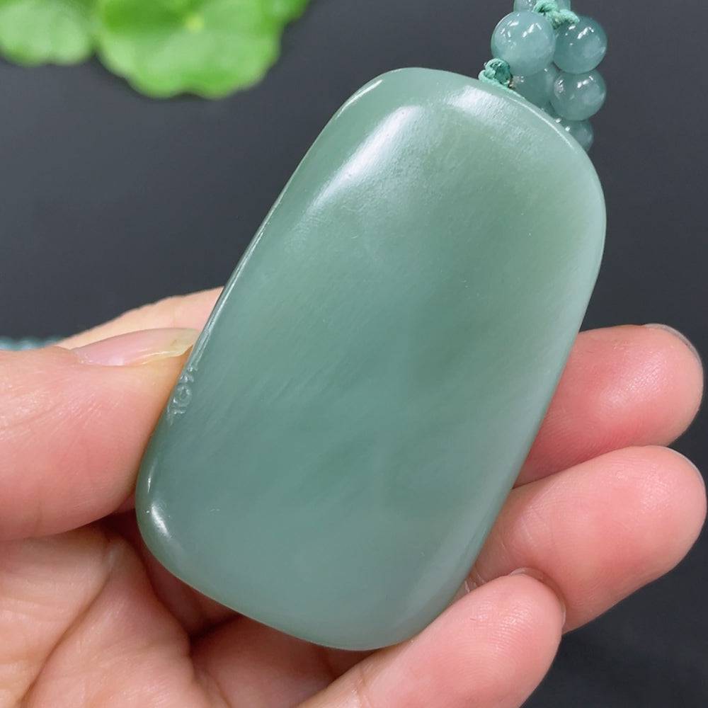 Huiliu certified Hetian jade pendant featuring Manjushri Bodhisattva with intricate carvings and polished finish.